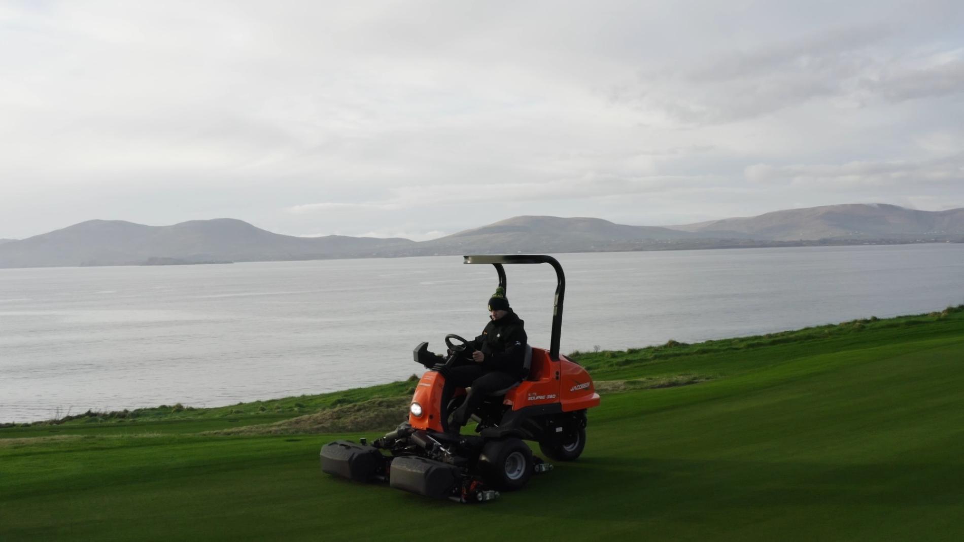 Mower on grass near water